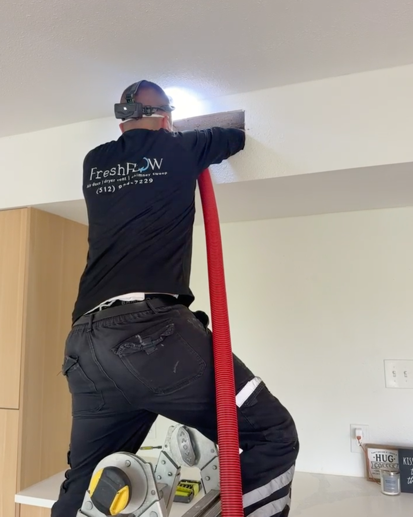 Fresh Flow Air Services FreshFlow technician working on air duct cleaning in Austin TX